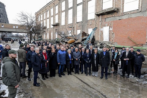 In this handout photograph taken and released by the Ukrainian Presidential Press Service on February 24, 2026, Ukraine's Defence Minister Denys Shmygal (C) poses for a photo with European Commission President Ursula von der Leyen, European Council President Antonio Costa and other European leaders as they visit the Darnytska combined heat and power plant damaged by Russian air strikes in Kyiv, as Ukraine marks the fourth anniversary of Russia's full-scale invasion.
