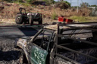 Burnt vehicles are pictured after a wave of violence in the town of Aguililla, the birthplace of drug kingpin Nemesio Oseguera, leader of the Jalisco New Generation Cartel (CJNG) in Tierra Caliente, Mexico, on February 24, 2026.