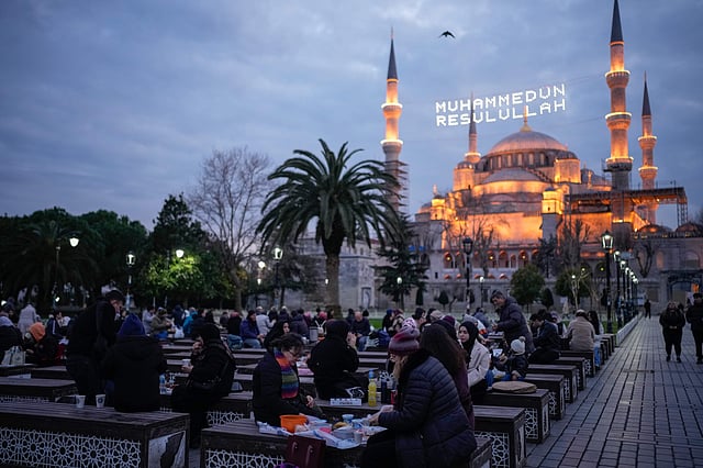 As the sun sets during the holy month of Ramadan, millions of Muslims worldwide gather for iftar — the cherished meal that marks the end of the fast. While customs vary by region, the essence of iftar remains the same: faith, gratitude, and togetherness. Above, people break their fast outside the Sultanahmet mosque, in Istanbul, Turkey.