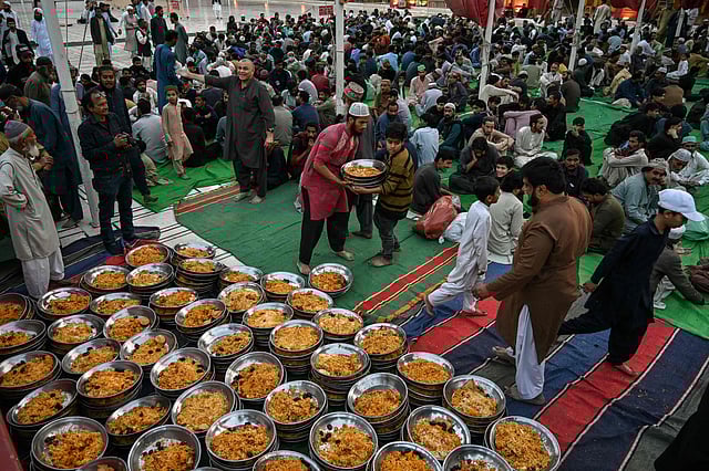 Volunteers distribute iftar meals at the New Memon mosque in Karachi.