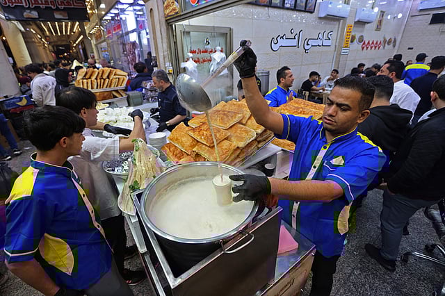 A worker serves a drink at a restaurant during the Muslim holy fasting month of Ramadan in Al-Sadriyah district of Baghdad on February 26, 2026.
