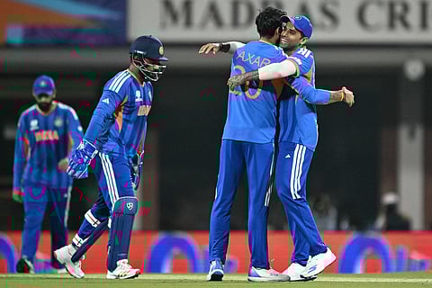 India's captain Suryakumar Yadav (R) congratulates teammate Axar Patel (2R) after the wicket of Zimbabwe's Tadiwanashe Marumani during the 2026 ICC Men's T20 Cricket World Cup Super Eights match between India and Zimbabwe at the MA Chidambaram Stadium in Chennai on February 26, 2026.