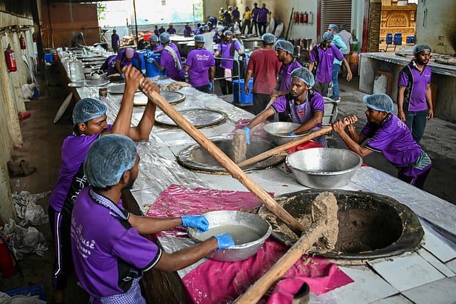 Cooks prepare 'Haleem', a traditional dish prepared with lamb and wheat, during the Islamic holy fasting month of Ramadan in Hyderabad.
