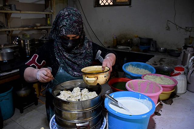An Afghan woman prepares traditional steamed dumplings, mantu, for iftar during Ramadan at a women-only restaurant in Mazar-i-Sharif.