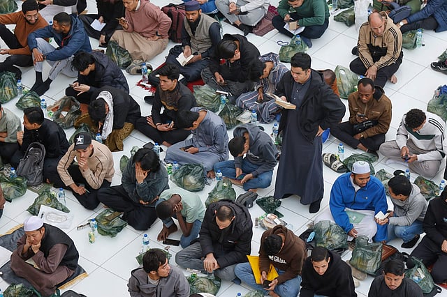 Worshippers wait to break their fast at a free meal distribution point at Al-Azhar Mosque in Cairo, Egypt, during Ramadan.