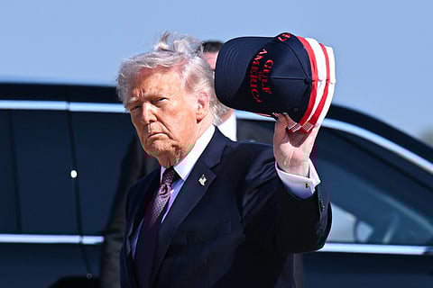 President Donald Trump waves a hat as he arrives at Corpus Christi International Airport on February 27, 2026 in Corpus Christi, Texas.