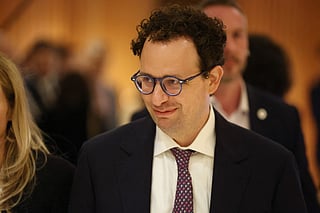 Anthropic CEO Dario Amodei looks on after a meeting with French President Emmanuel Macron during the AI Impact Summit in New Delhi on February 19, 2026.