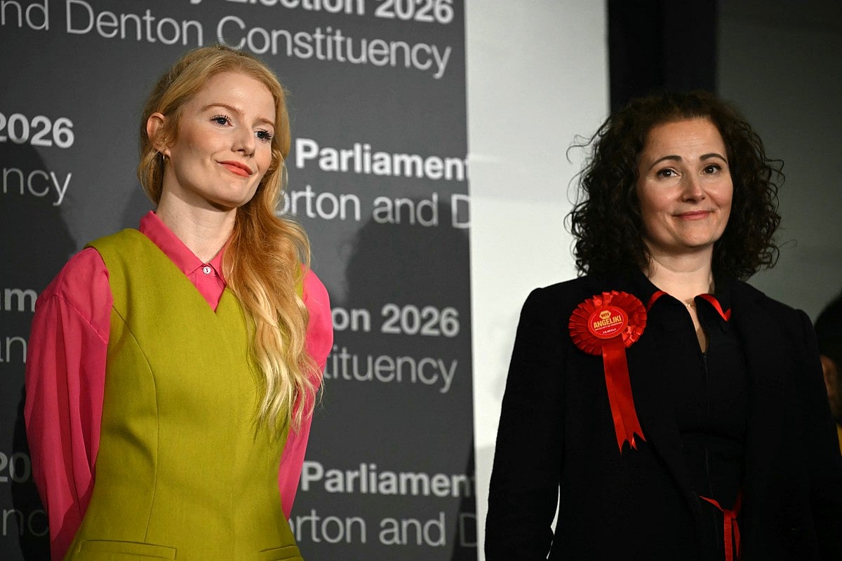 Green Party candidate Hannah Spencer (L) stands alongside Labour party candidate Angeliki Stogia as she is announced as the winner of the Gorton and Denton Parliamentary by-election, at Manchester Central Convention Complex in Manchester, northern England on February 27, 2026.