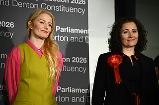 Green Party candidate Hannah Spencer (L) stands alongside Labour party candidate Angeliki Stogia as she is announced as the winner of the Gorton and Denton Parliamentary by-election, at Manchester Central Convention Complex in Manchester, northern England on February 27, 2026.