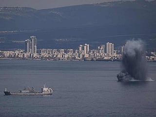 An incoming projectile explodes over the water as Israel issues a nationwide alert following its strikes on Iran, in Haifa Bay, northern Israel, Saturday, Feb. 28, 2026. 
