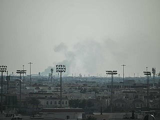 Smoke rises from an area in the direction of Al Udeid Air Base, which houses the Qatar Emiri Air Force and foreign forces including the US, in Doha on February 28, 2026, following a reported Iranian strike. 