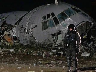 A military police stands next to a plane that crashed in El Alto, Bolivia. 