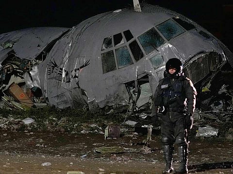 A military police stands next to a plane that crashed in El Alto, Bolivia. 