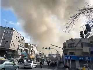 A plume of smoke rises following a reported explosion in Tehran. 
