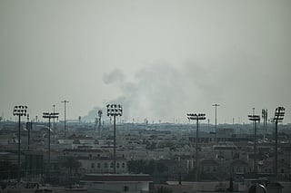 Smoke rises from an area in the direction of Al Udeid Air Base, which houses the Qatar Emiri Air Force and foreign forces including the US, in Doha on February 28, 2026, following a reported Iranian strike.