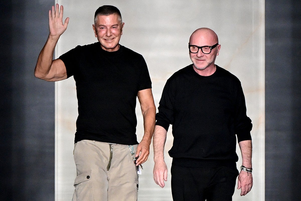 Italian stylists Domenico Dolce (R) and Stefano Gabbana (L) salute the audience at the end of the Dolce & Gabbana women's ready-to-wear Fall/Winter 2026 collection show
