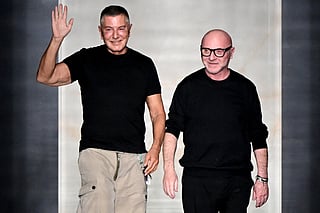 Italian stylists Domenico Dolce (R) and Stefano Gabbana (L) salute the audience at the end of the Dolce & Gabbana women's ready-to-wear Fall/Winter 2026 collection show