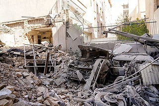 This picture obtained from Iran's ISNA news agency, shows the rubble and debris covering destroyed vehicle following a missile strike on a neighborhood of the Iranian capital Tehran on February 28, 2026.