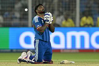 India's Sanju Samson prays as he celebrates his team's win against West Indies at the end of their 2026 ICC Men's T20 Cricket World Cup Super Eights match in the Eden Gardens, Kolkata on March 1, 2026.