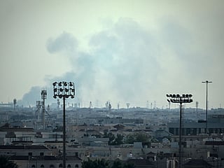 Smoke rises from an area in the direction of Al Udeid Air Base.