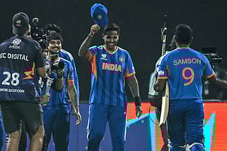 India's captain Suryakumar Yadav (C) greets his teammate Sanju Samson (R) after their team's win in the 2026 ICC Men's T20 Cricket World Cup Super Eights match between India and West Indies at the Eden Gardens in Kolkata on March 1, 2026.