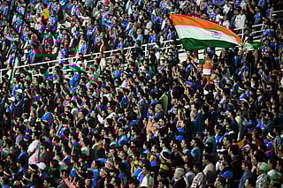 Fans wave India's national flag before the start of the 2026 ICC Men's T20 Cricket World Cup Super Eights match between India and West Indies at the Eden Gardens in Kolkata on March 1, 2026.