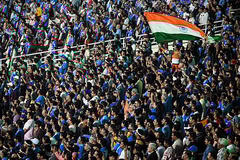 Fans wave India's national flag before the start of the 2026 ICC Men's T20 Cricket World Cup Super Eights match between India and West Indies at the Eden Gardens in Kolkata on March 1, 2026.