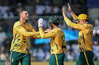 South Africa's George Linde (L) celebrates with teammates after taking the wicket of Zimbabwe's Dion Myers during the 2026 ICC Men's T20 Cricket World Cup Super Eights match between Zimbabwe and South Africa at the Arun Jaitley Stadium in New Delhi on March 1, 2026.
