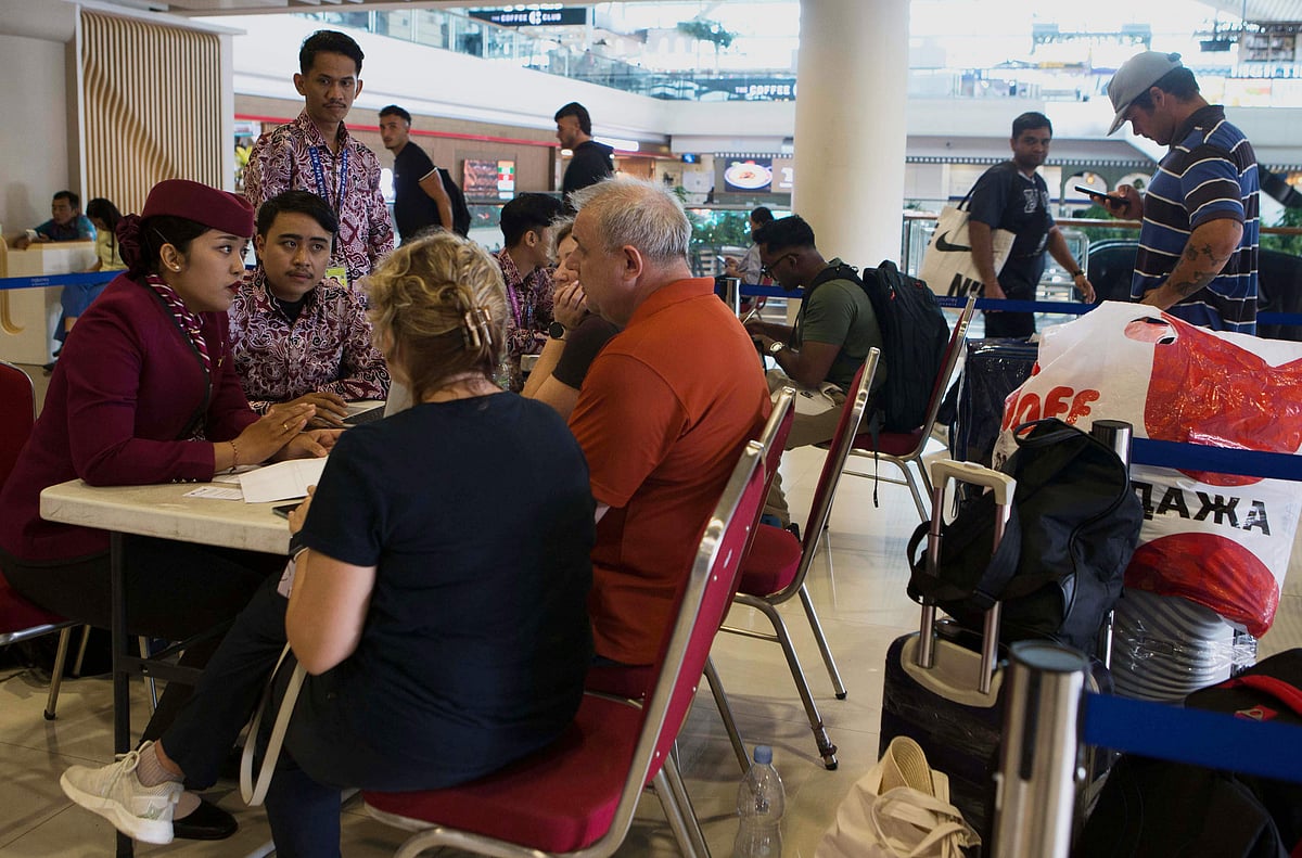 Stranded travellers speak with airline staff after flights to the Middle East were cancelled following the US-Israeli attack on Iran, at Ngurah Rai International Airport in Kuta, Bali, Indonesia. Hundreds of thousands of passengers worldwide remain stranded as widespread cancellations trigger the worst travel disruption since the COVID-19 pandemic, with escalating regional tensions forcing major airspace closures across the Middle East.