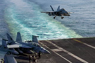 This image provided by U.S. Central Command shows a F/A-18E Super Hornet preparing to make an arrested landing on the USS Abraham Lincoln (CVN 72) after a mission in support of Operation Epic Fury, on Saturday, Feb. 28, 2026. 