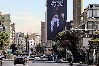 A billboard of Iran’s slain supreme leader Ayatollah Ali Khamenei reading in Persian "His God is still alive" in Tehran on March 3, 2026.