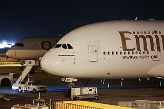 An Emirates airliner sits parked at Los Angeles International Airport (LAX) in Los Angeles, California on March 2, 2026, after its return flight to Dubai International Airport (DXB) was cancelled due to the war in the Middle East.