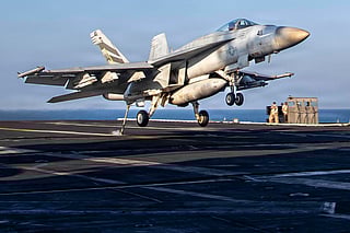 This US Navy handout photo released by US Central Command public affairs shows an F/A-18E Super Hornet, attached to Strike Fighter Squadron (VFA) 151, making an arrested landing on the flight deck of Nimitz-class aircraft carrier USS Abraham Lincoln (CVN 72) in support of Operation Epic Fury on March 3, 2026.