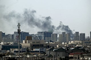 A plume of smoke rises over buildings in Doha on March 5, 2026.
