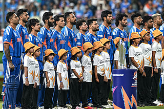 India's players stand for their national anthem before the start of the 2026 ICC Men's T20 Cricket World Cup semi-final match between India and England at the Wankhede Stadium in Mumbai on March 5, 2026.