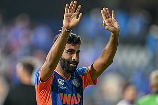 India's Jasprit Bumrah waves to fans at the end of the semi-final match between India and England