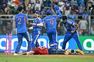 India's players celebrate after the dismissal of England's Jacob Bethell (bottom) during the 2026 ICC Men's T20 Cricket World Cup semi-final match between India and England at the Wankhede Stadium in Mumbai on March 5, 2026.