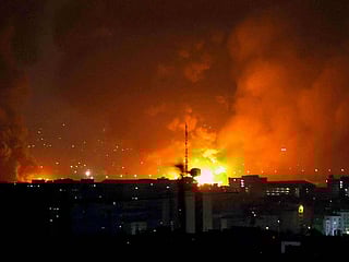 Smoke and fire rise from the site of airstrikes at Mehrabad International Airport in Tehran on March 7, 2026. 