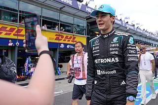 Mercedes driver George Russell of Britain walks down pit lane after winning the qualifying session for the Australian Formula One Grand Prix at Albert Park, in Melbourne, Australia, Saturday, March 7, 2026. (AP Photo/Asanka Brendon Ratnayake)