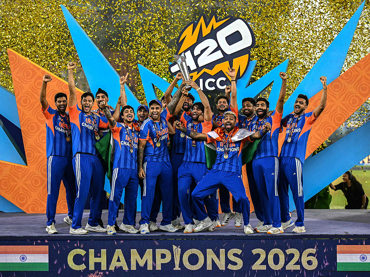 India's players celebrate with the trophy after winning the 2026 ICC Men's T20 Cricket World Cup final match against New Zealand at the Narendra Modi Stadium in Ahmedabad on March 8, 2026. 