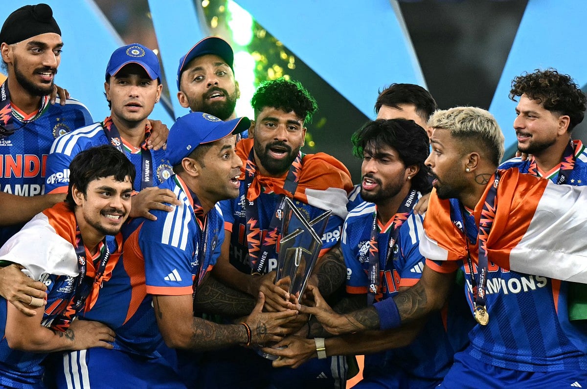 India's players celebrate with the trophy after winning the 2026 ICC Men's T20 Cricket World Cup final match against New Zealand at the Narendra Modi Stadium in Ahmedabad on March 8, 2026.