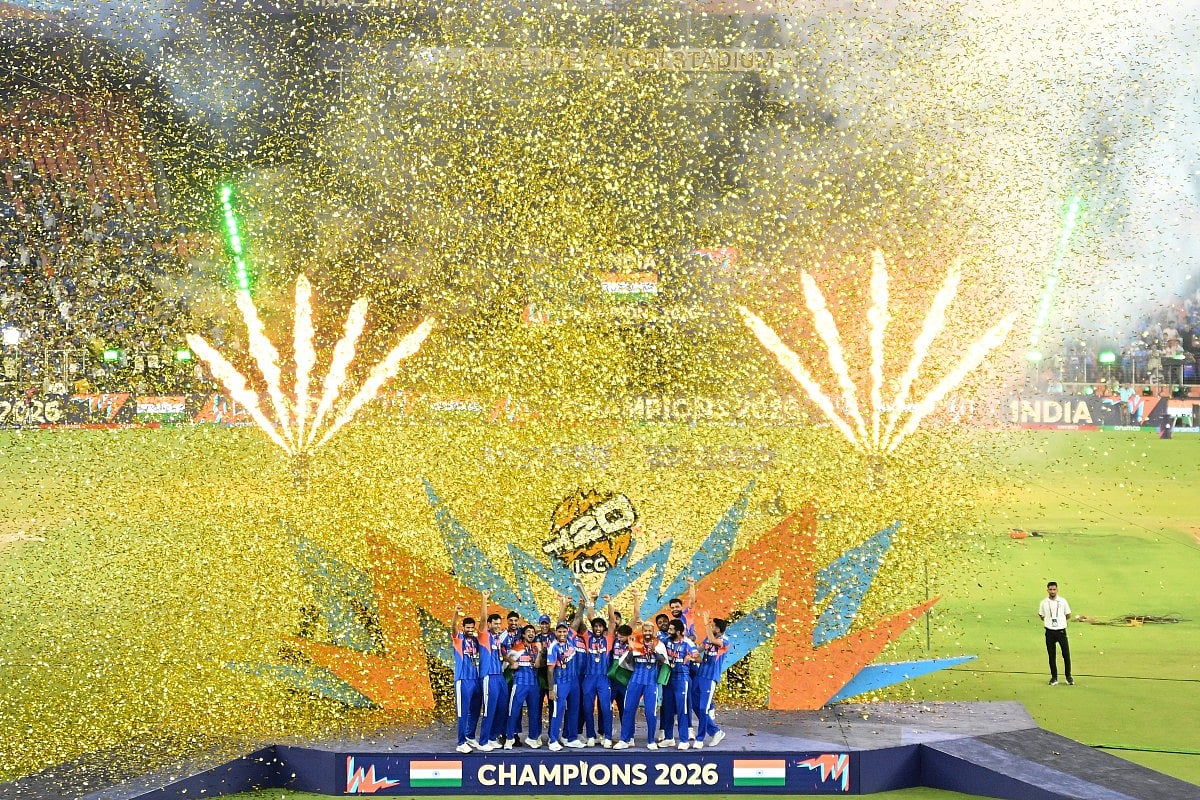 India's players celebrate with the trophy after winning the 2026 ICC Men's T20 Cricket World Cup final match against New Zealand at the Narendra Modi Stadium in Ahmedabad on March 8, 2026.