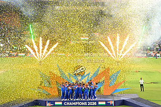India's players celebrate with the trophy after winning the 2026 ICC Men's T20 Cricket World Cup final match against New Zealand at the Narendra Modi Stadium in Ahmedabad on March 8, 2026.