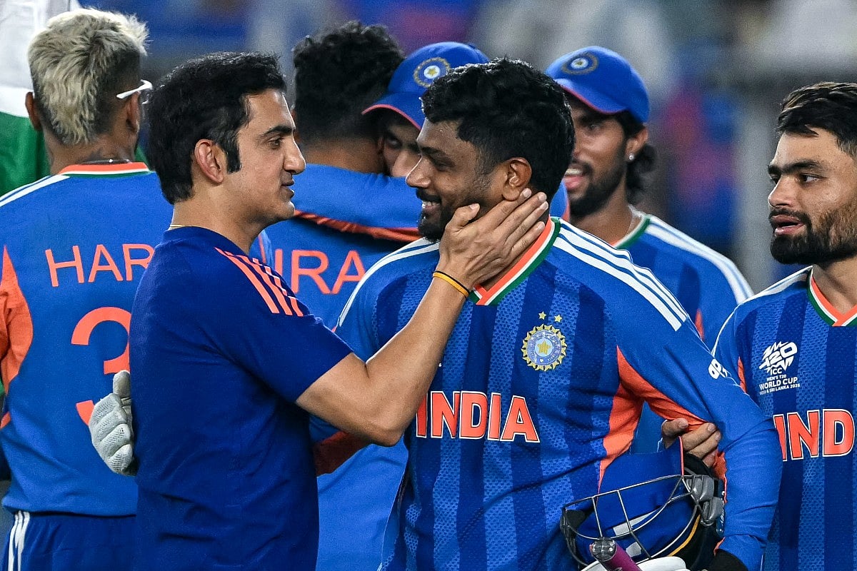India's Sanju Samson (C) celebrates with his coach Gautam Gambhir (L) after their team's win in the 2026 ICC Men's T20 Cricket World Cup final match against New Zealand at the Narendra Modi Stadium in Ahmedabad on March 8, 2026.