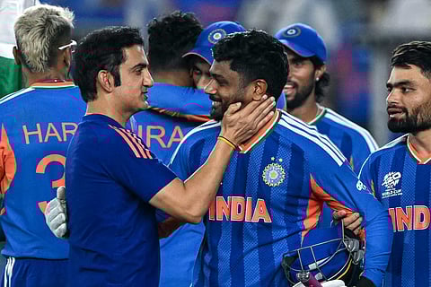 India's Sanju Samson (C) celebrates with his coach Gautam Gambhir (L) after their team's win in the 2026 ICC Men's T20 Cricket World Cup final match against New Zealand at the Narendra Modi Stadium in Ahmedabad on March 8, 2026.