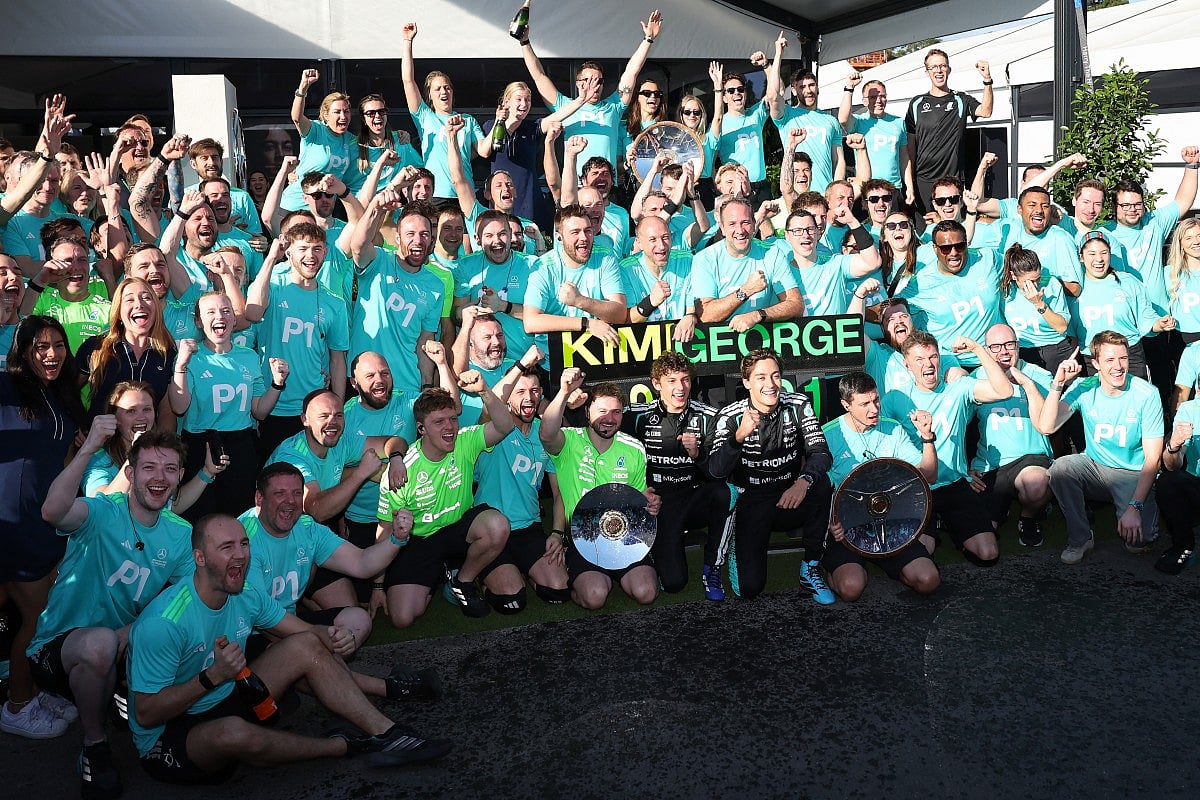 Mercedes’ British driver George Russell (5th R) and teammate Kimi Antonelli of Italy celebrate with team members after winning the Formula One Australian Grand Prix at Melbourne’s Albert Park Circuit on March 8, 2026.