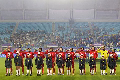 Iranian players salute during the national anthem before the AFC Women's Asian Cup Australia 2026 football match between Iran and Philippines in Gold Coast on March 8, 2026.