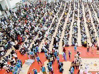 Volunteers with Model Service Society distribute iftar meals.  