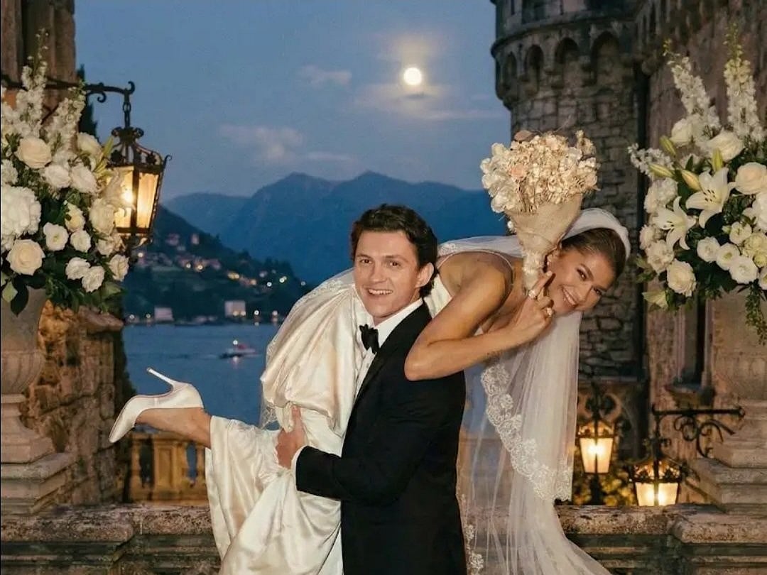 The dreamy image shows Zendaya in a white wedding gown, topped with a delicate floral veil, while Holland stands beside her in a classic tux