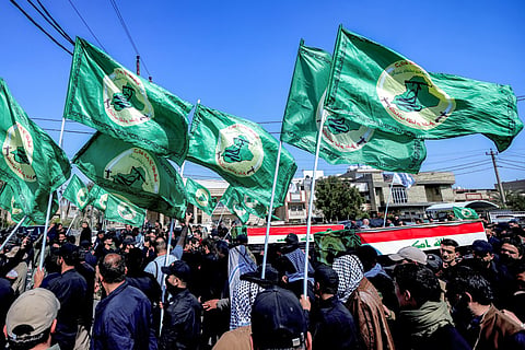 Mourners attend a funeral for members of Iraq's Hashed Al-Shaabi, or the Popular Mobilisation Forces (PMF) -- an alliance of factions now integrated into the regular army that also includes powerful Iran-backed groups -- who were killed in reported strikes on Kirkuk, in Baghdad on March 10, 2026.